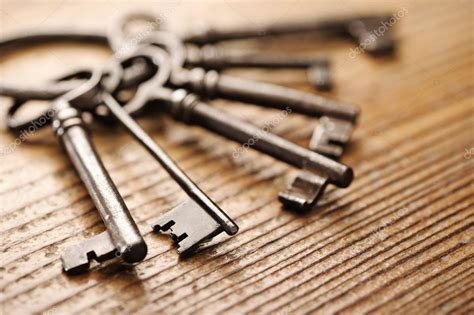 Old keys on a wooden table, close-up Stock Photo by ©stokkete 8477398