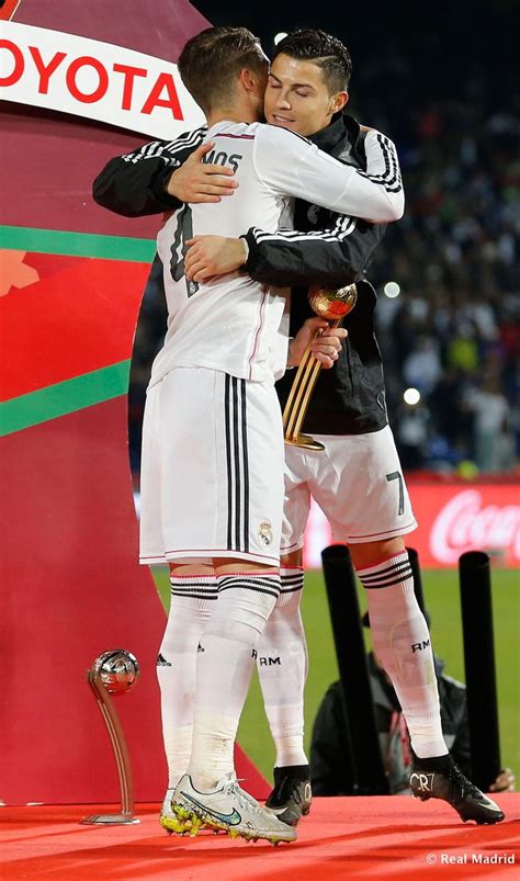 two soccer players hugging each other on the field