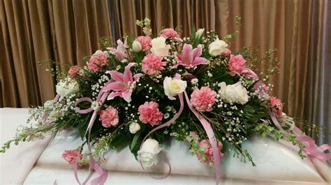 Delicate pink child casket spray. Star gazer lilies, roses, carnations ...