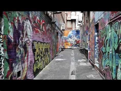 Stock footage of an alleyway full of graffiti art on wall : Graffiti