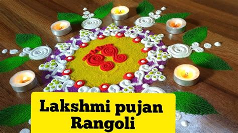 a decorated rangoli with candles on a wooden table