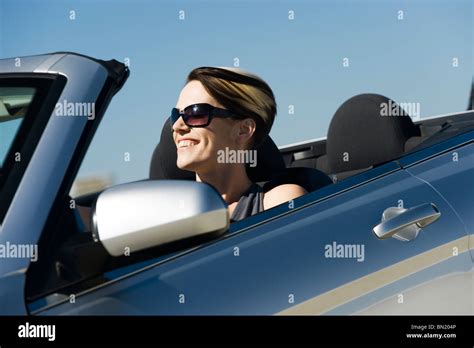 Woman driving convertible Stock Photo - Alamy