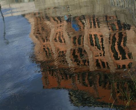 Premium Photo | Reflection of building in pond