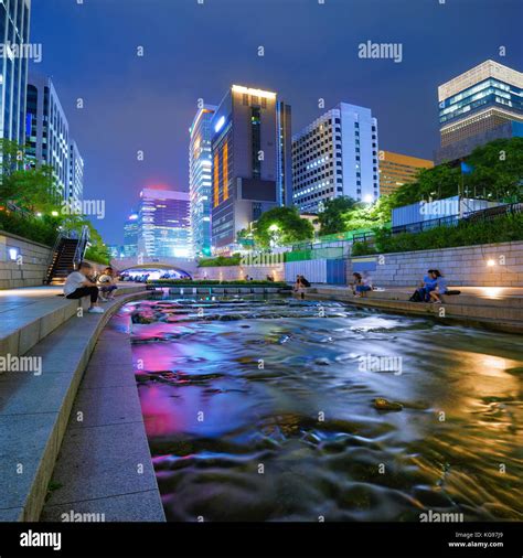 Colorful city lights of Cheonggyecheon Stream Park with Crowd at night ...