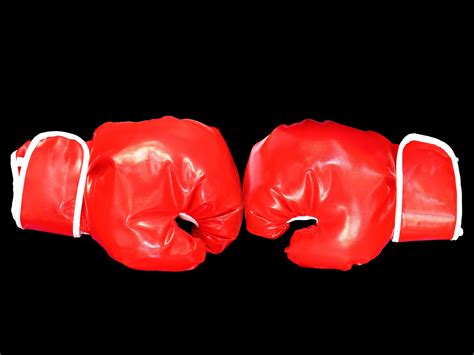 Red boxing gloves on black background. 8372874 Stock Photo at Vecteezy