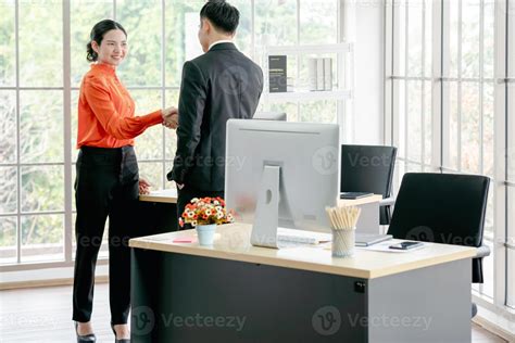 Business people shaking hands in office 10048420 Stock Photo at Vecteezy