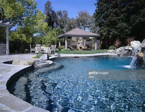 Swimming Pool With Waterfall In Backyard High-Res Stock Photo - Getty ...