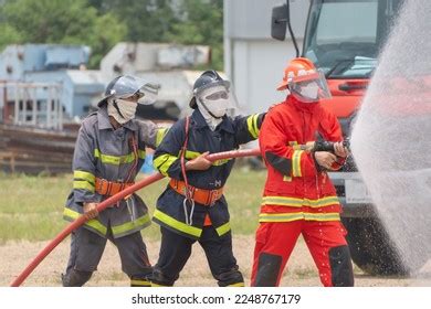 Firefighters Working Team Extinguish Burning Fire Stock Photo ...