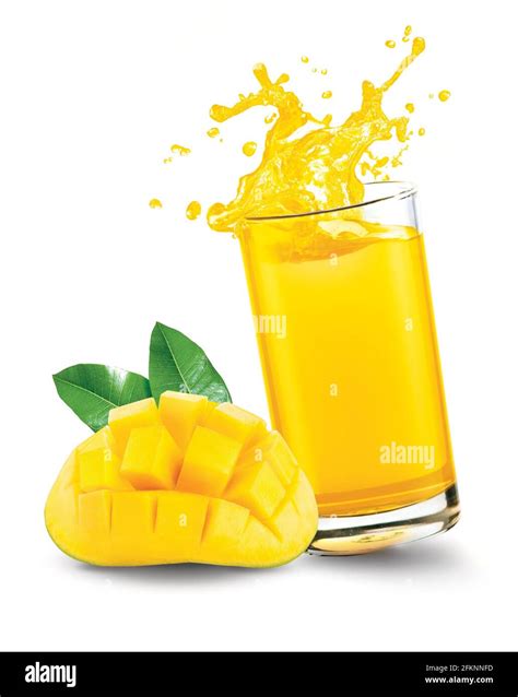 Mango juice splash out of glass with mango fruit on white background ...