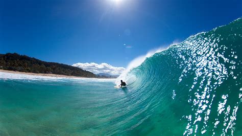 Water view of a surfer getting barreled at Pupukea Sandbar, Hawaii ...