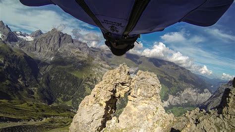 An Insane Wingsuit Flight Through a Tiny Two-Meter Opening Between Rock ...