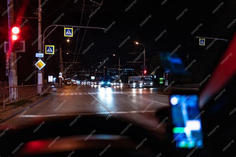 Premium Photo | A view from inside the car driving at night in the city ...