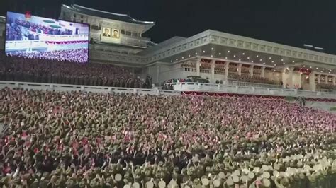 Kim Jong Un shows off daughter, missiles at North Korean military parade