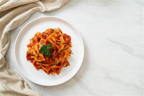 Farfalle pasta in tomato sauce with parsley - Italian food style ...