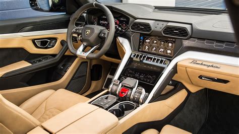 the interior of a sports car with tan leather and black trims, steering ...