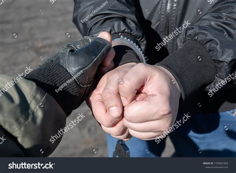 Arrest Criminal Police Officer Puts Handcuffs Stock Photo 1729831063 ...