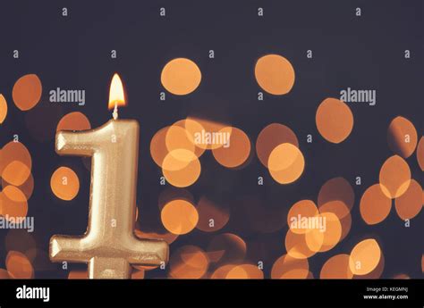 Gold number 1 celebration candle against blurred light background Stock ...