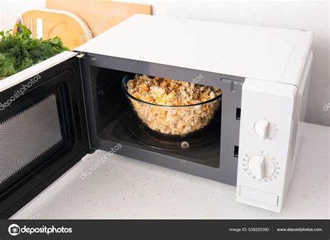 Modern Microwave Oven Bowl Popcorn Counter Light Wall Stock Photo by ...