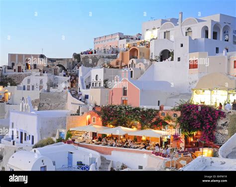 Oia village restaurant and houses at sunset Stock Photo - Alamy