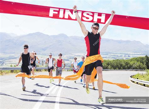 Runner crossing race finish line — people, success - Stock Photo ...