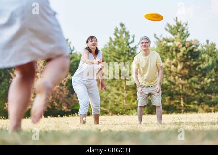 Group of people playing Frisbee in the park Stock Photo - Alamy