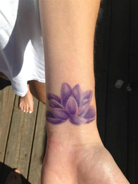 Tiny Purple Lotus Wrist Tattoo by Rob Levis