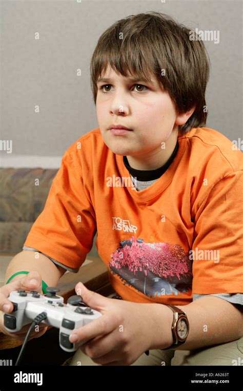 portrait of a young boy playing playstation Stock Photo - Alamy