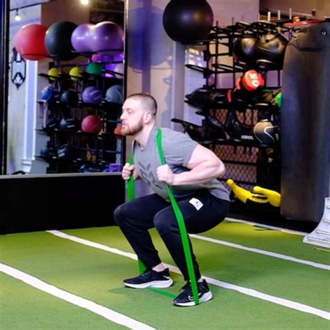 a man is doing exercises with a resistance band