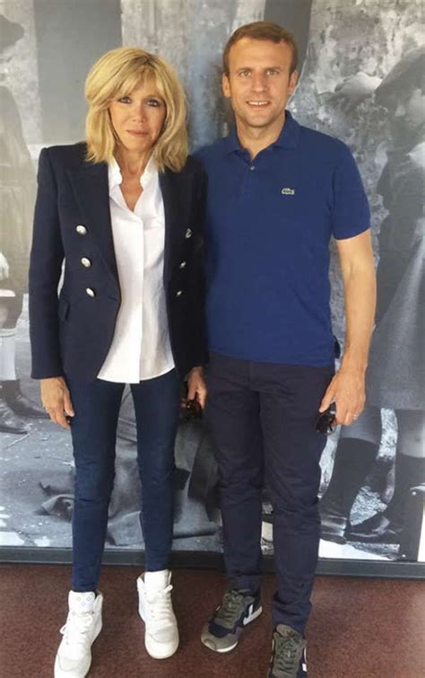 a man and woman standing next to each other in front of a wall with ...