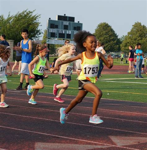 young children running on a track in a race