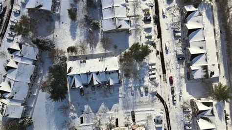 Premium Photo | Aerial view in small town a snow covered roof of with ...