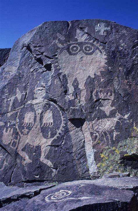 Ancient Pueblo-Anasazi rock art of a warrior with a bear claw shield ...