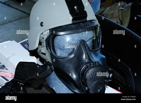 Police riot helmet and gas mask on display at convention Stock Photo ...