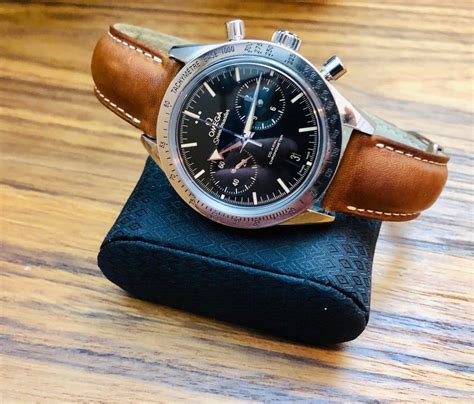 Omega Speedmaster ‘57 on a tan leather Omega strap.