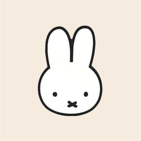 a white rabbit face with black ears