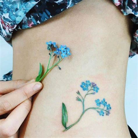 Forget-me-not flower tattoo on the left side of the