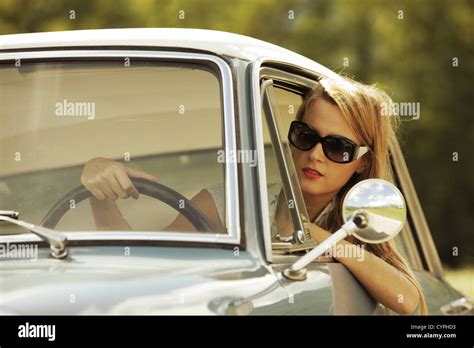 Young woman driving vintage car Stock Photo - Alamy