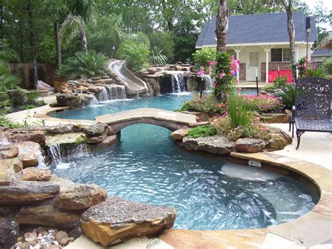 Natural mossrock waterfall pool with slide, beach entry and small river ...