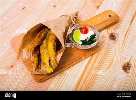 Fish and chips with creamy cheese sauce Stock Photo - Alamy