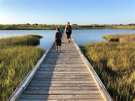 Family crossing over bridge on the Galveston Island Trail. # ...