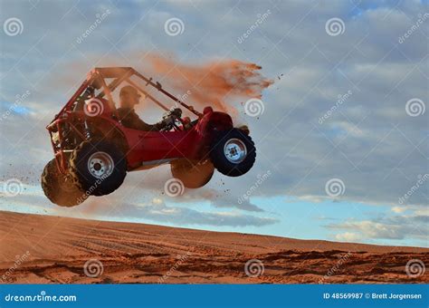 Man Jumping Quad through the Air on Sand Dune Stock Image - Image of ...