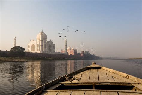 Wooden Boat on the Yamuna River with Taj Mahal and Bird Fly Over. Stock ...