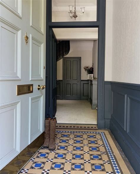 an entry way with blue and white tile on the floor next to a doorway ...