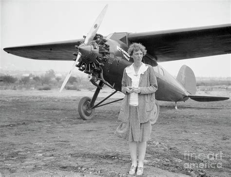 Amelia Earhart Posing With Her Plane by Bettmann