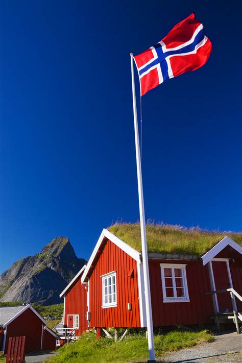 Norwegian Flag Flying Above a Mountain Cabin