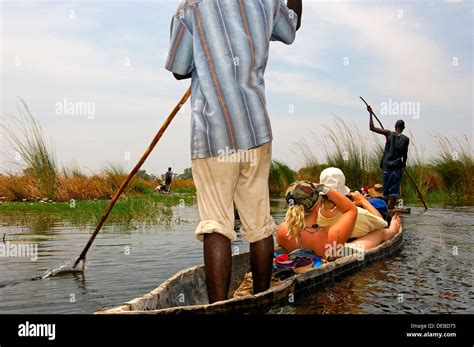 Tourists on a trip in a Mokoro canoe in the Okavango Delta, Botswana ...