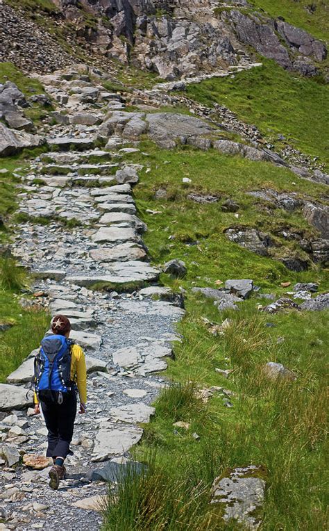 Woman With Rucksack Hiking Up Rocky Path Photograph by Cavan Images ...