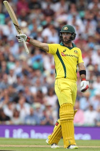 Glenn Maxwell of Australia raises his bat after reaching a half century ...