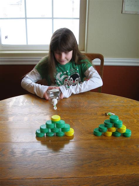 Almost Unschoolers: Newton's 3rd Law of Motion - Knocking Down Milk Caps