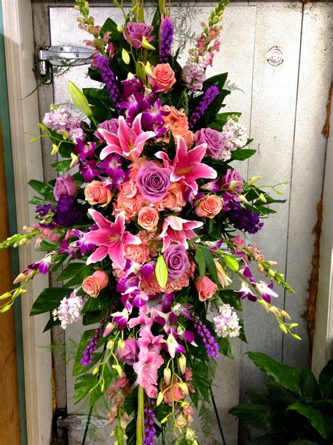 Funeral Standing Spray with pinks and violets focal flowers being pink ...